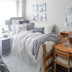 a bedroom with white and gray decor on the walls