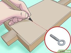 a person is cutting paper with a pencil and screwdriver on top of a wooden box