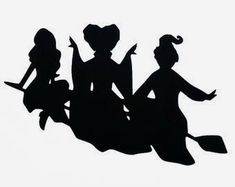 the silhouettes of three women are holding paddles