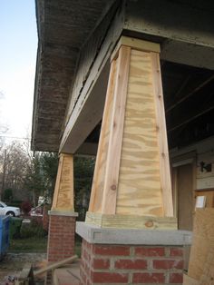 a brick chimney being built in front of a house