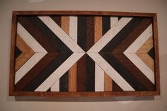 a wooden wall hanging with an arrow design on it