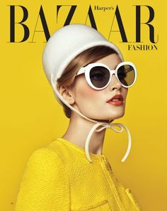 a woman wearing sunglasses and a hat on the cover of harper magazine, with yellow background