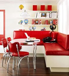 a red and white dining room with two booth seats, a round table and four chairs