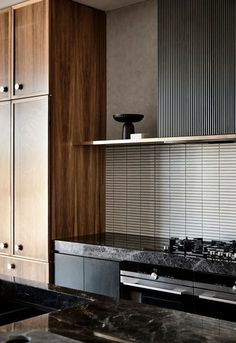 a kitchen with marble counter tops and wooden cabinets