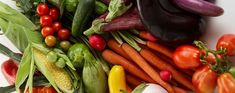 many different types of vegetables on a white surface