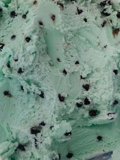 an ice cream dish with chocolate chip cookies on the top and mint green icing