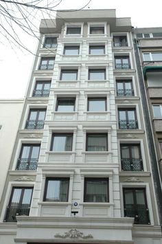 an apartment building with many windows and balconies