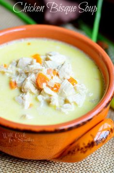 a bowl filled with chicken biscuit soup on top of a table