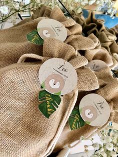 some brown burlock bags with stickers on them and flowers in the background