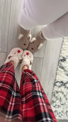 two people wearing plaid pants and slippers standing next to each other on the floor