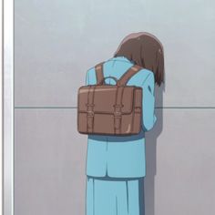 a person with a backpack on their back standing in front of a wall and looking into the distance