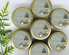 six tins with christmas themed labels on them