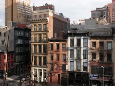 the city is full of tall buildings with lots of windows and balconies on them