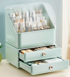 a blue desk with drawers filled with pens and pencils