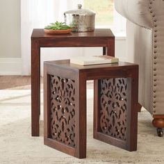 two wooden tables sitting on top of a carpeted floor