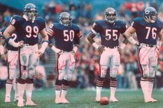 three football players are standing on the field