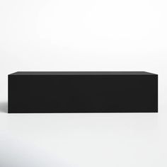 a black rectangular object sitting on top of a white surface with no one around it