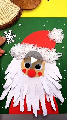 someone is making a paper santa claus craft