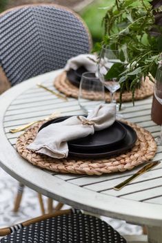 an outdoor table set for two with place settings