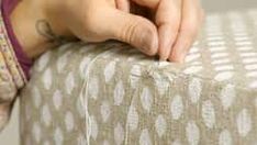 a woman's hand resting on the edge of a bed