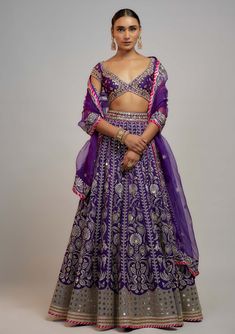 Editor's Note Adorn yourself in our exquisite deep purple brocade lehenga skirt, adorned with stunning gold and silver thread and sequins, paired elegantly with a meticulously handcrafted blouse this lehenga set is perfected with an embroidered organza dupatta, creating a truly enchanting ensemble. Dark Purple Lehenga, Violet Lehenga, Modern Lehenga Designs, Lehenga Purple, Indian Fits, Wedding September, Purple Lehenga, Brocade Lehenga, Desi Vibes