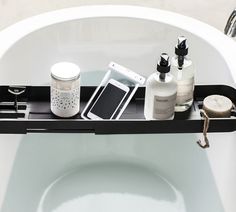 a bathtub tray with various items on it