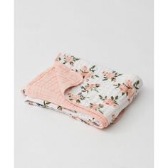 two baby blankets with pink and white flowers on them, one is folded over the other