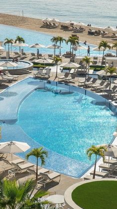 an aerial view of a resort pool and beach