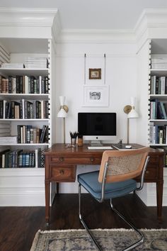 a home office with bookshelves, desk and chair in front of the computer