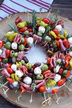 a platter filled with different types of meats and vegetables on skewers