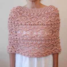 a woman wearing a pink crocheted shawl