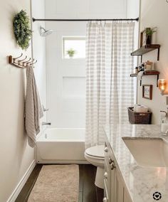 a bathroom with a sink, toilet and bathtub next to a window in it