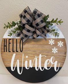 a wooden sign that says hello winter on it