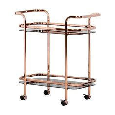 a gold serving cart with glass shelves and wheels