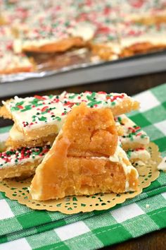 several pieces of cake sitting on top of a green and white checkered table cloth