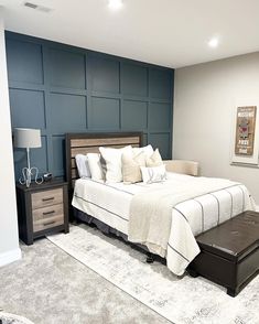 a bedroom with a large bed, dresser and night stand