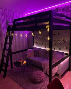 a loft bed is lit up with purple lights in the room and has a futon sofa underneath it