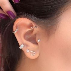 a close up of a person with ear piercings on their ears and one behind the ear