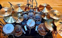 a bunch of drums sitting on top of a wooden floor