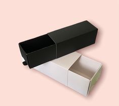 an open black and white box on a pink background