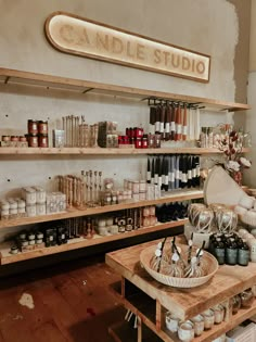 a store filled with lots of bottles and jars on wooden shelves next to each other