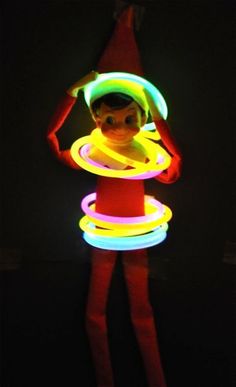 a woman in red tights and neon lights with her hands on her hips,