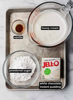 ingredients to make jello - o pudding laid out on a baking tray, including milk, sugar and jelly