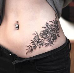 a close up of a woman's stomach with flowers on it