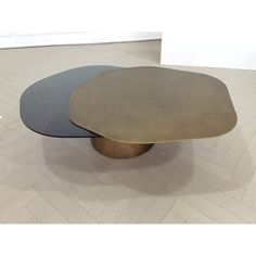 two tables sitting on top of each other in the middle of a room with white walls