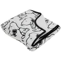 a black and white blanket with cartoon animals on it's side, folded up