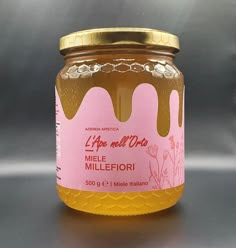 a jar of honey sitting on top of a table