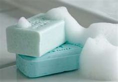 two soap bars sitting next to each other on top of a white surface with snow around them