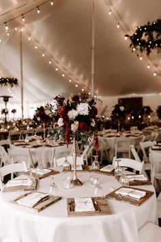 the tables are set up with white linens and silverware