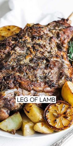 a white plate topped with steak, potatoes and rosemary garnished with the words leg of lamb